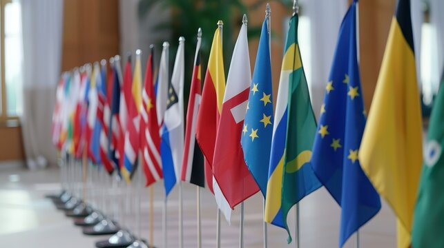 A row of international flags displayed in a conference room, symbolizing global diplomacy, unity, and international relations.