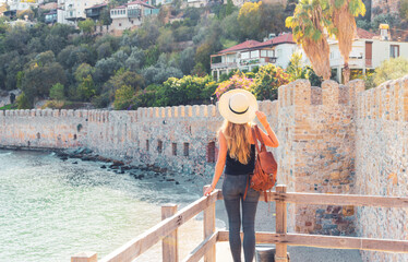 Fototapeta premium tourist woman traveling in Turkey, Antalya, red tower in Alanya