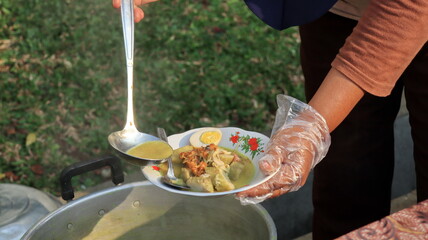 Lontong sayur. Rice cake with vegetable curry and spicy boiled egg