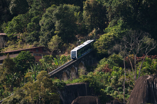 PENANG, MALAYSIA - FEB 21, 2024: Penang Hill funicular on railway tracks, surrounded by lush nature.
