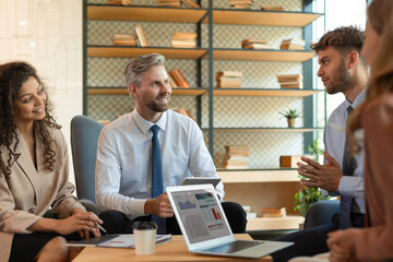 Group of happy progressive business people working on startup together at creative office