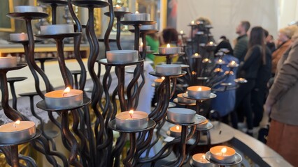 Burning candles in a Catholic church during the Divine Service.