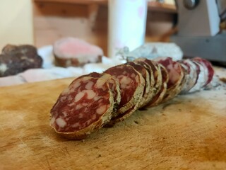 Rustic Sliced Italian Salami on Wooden Board: Traditional Cured Meat Charcuterie