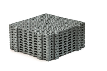 Stack of Anti-slip rubber mats in the bathroom, isolated on white background panels have a grid-like pattern on their surface, providing a sturdy and slip-resistant surface panels are stacked neatly