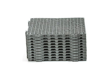 Stack of Anti-slip rubber mats in the bathroom, isolated on white background panels have a grid-like pattern on their surface, providing a sturdy and slip-resistant surface panels are stacked neatly