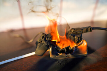 Fire socket of electricity plug switch. Burning socket. Outlets, plug in fire. Short circuit in...