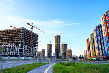 Construction site in Cityscape. Residential Building under Construction. Tower Crane on formworks. House Construction. Tower Cranes on Skyscrapers Construction. Redevelopment urban areas in city.