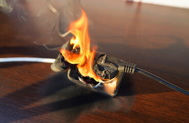 Fire socket of electricity plug switch. Burning socket. Outlets, plug in fire. Short circuit in...