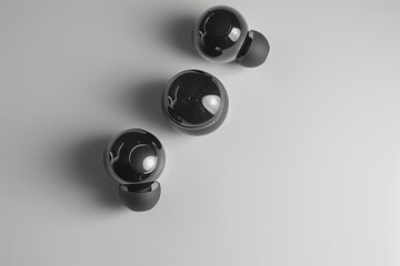 pair of black earphones on red surface, pair of high-end wireless earbuds on solid color background presenting sophistication and luxury