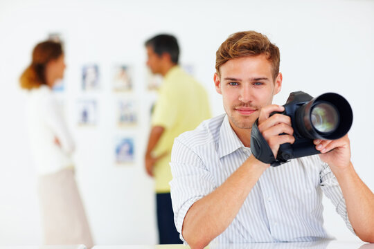 Portrait, photographer and man with camera, intern and photography in office, creative and journalist. Proud, reporter and smile for opportunity in newsroom, confident and storytelling of person