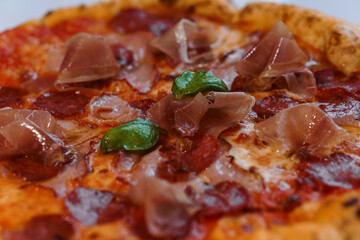 Pizza with salami and prosciutto. Meat pizza with cheese