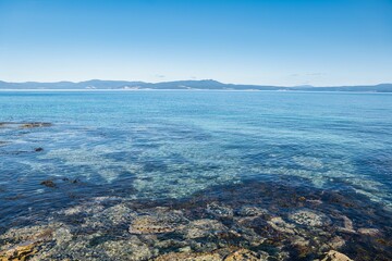 View of the Tasmanian coastline from Maria Island. Maria Island, Tasmania, Australia. Beautiful clear water around Maria Island. 