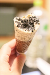 Indulgent Handheld Cookies and Cream Ice Cream Cone