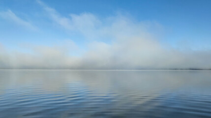 The sky is reflected in the water, the lake, the clouds are reflected in the water, morning on the lake, fog on the lake, morning fog