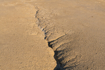 Arid landscape with mud rivers formations in Romania. This is a unique geological phenomenon where the earth gas reaches the surface through hills making small mud volcanoes and a remarkable landscape