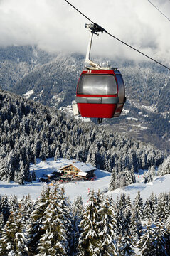 Vintage ski gondolas over Courchevel ski resort by winter
