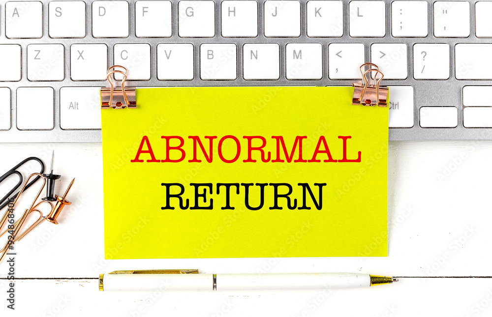 Aufkleber abnormal return text on yellow sticky on keyboard