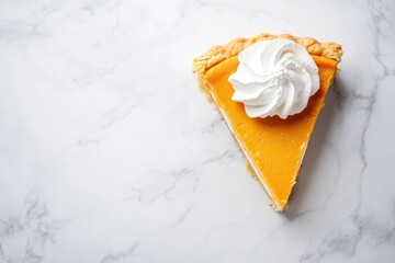 A Slice of Pumpkin Pie with Whipped Cream on Marble