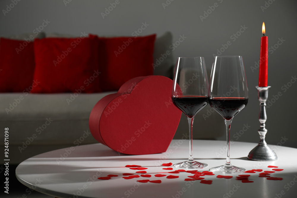 Canvas Prints Burning candle, wine in glasses and paper hearts on table indoors