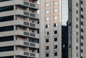 many windows and walls facade of a modern skyscraper without people