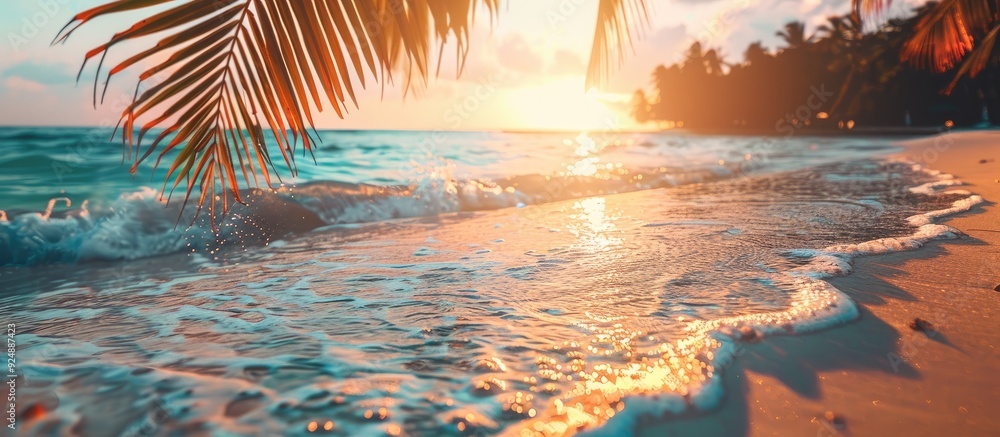 Aufkleber sunset on a tropical beach with soft waves and blurred sunlight in the background ideal for a busine