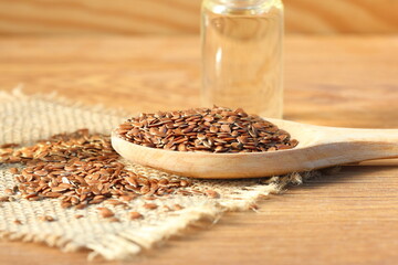 flaxseeds and flaxseed oil on wooden background