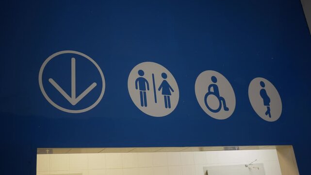 Toilets entrance. WC sign - man, woman, for people with disabilities, pregnant women. Public place like airport terminal, hospital, bus or train station and any other type. Clean. Indoor. Corridor