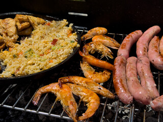 Grilled Delights: Shrimp, Sausages, Fried Rice, and Chicken on a Barbecue