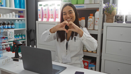 Young, brunette, woman, making, heart, gesture, indoors, smiling, in, pharmacy, store