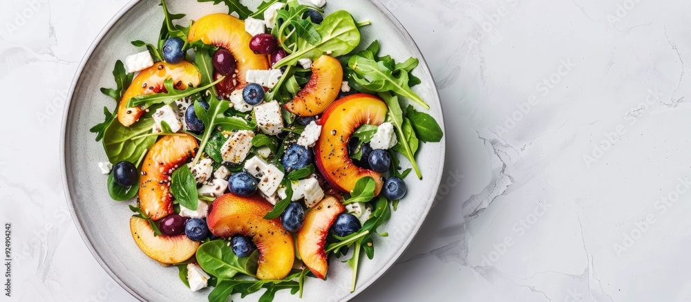 Poster healthy vegetarian salad featuring nectarines blueberries arugula spinach and feta cheese on a white