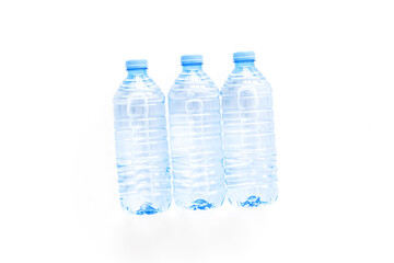 Pure water in plastic bottles on white background top view