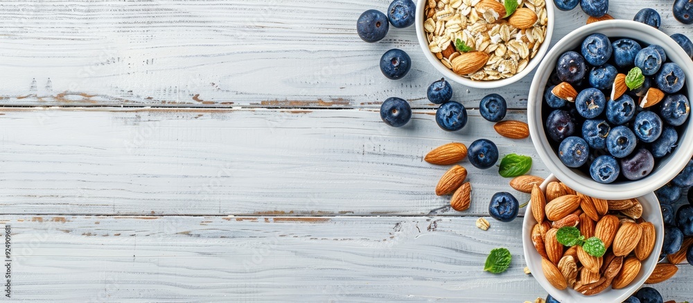 Poster top view of a white wooden background with a breakfast oatmeal featuring blueberries and almonds pro