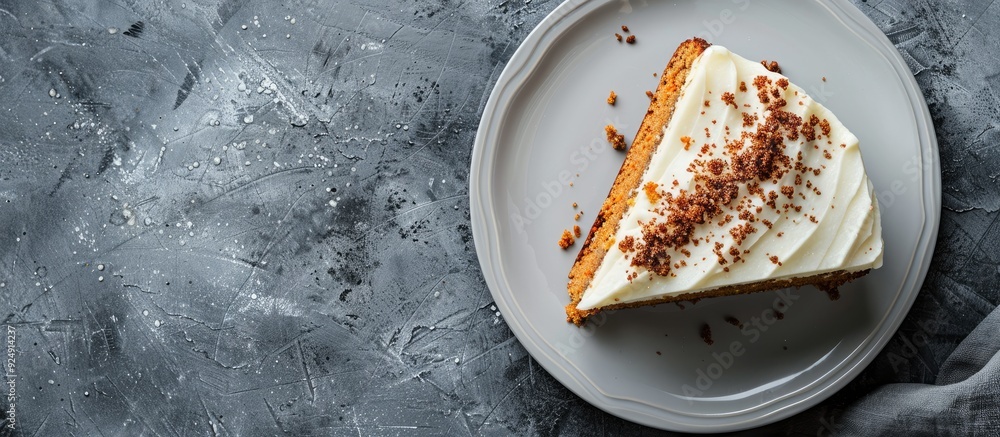 Poster Top view of a vegan raw carrot cake on a gray stone surface with copy space and selective focus showcasing a slice of healthy homemade cake