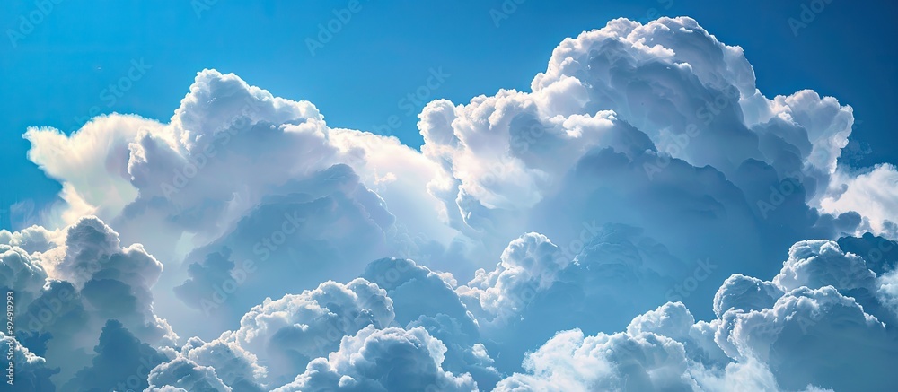 Leinwandbilder picture showing stunning fluffy cumulus clouds set against a vivid blue sky with ample space for add