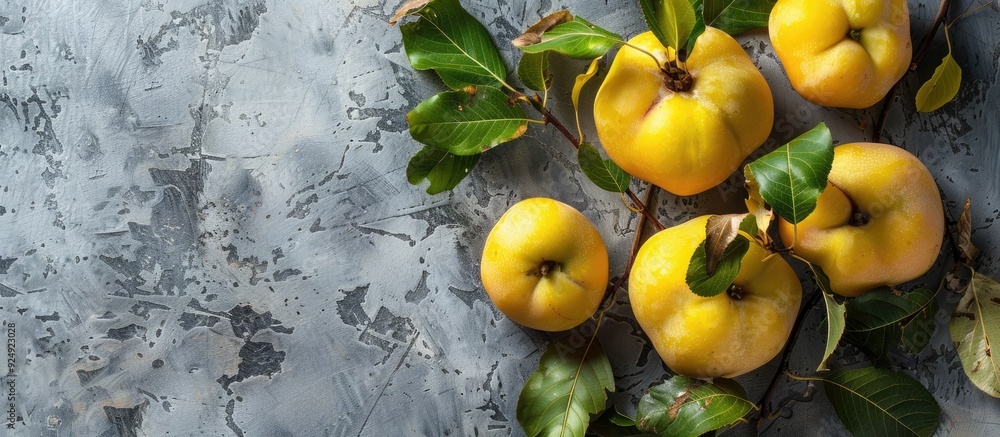 Aufkleber Fresh organic quinces with leaves on a grey table top view perfect for adding text in the copy space image