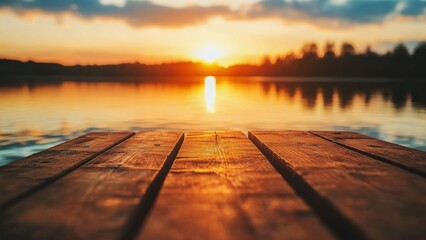 close-up of wooden pier at sunset, lake with warm reflections on water