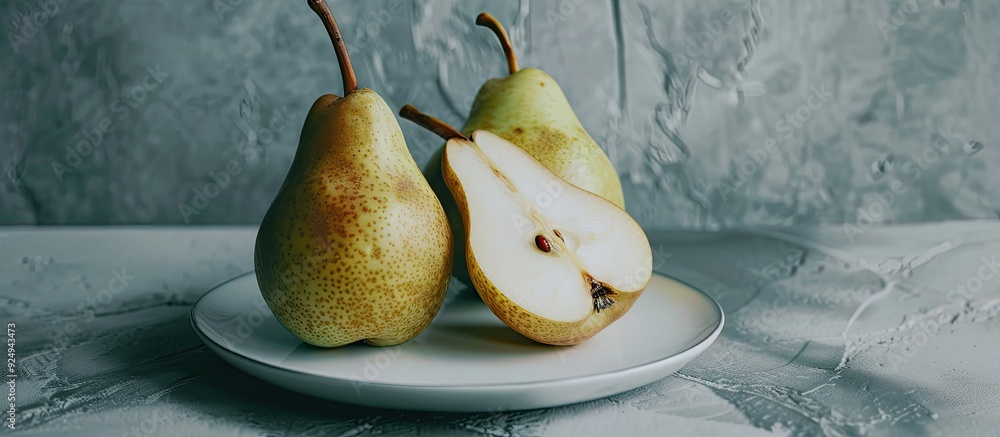 Aufkleber A collection of pears on a white plate with one pear halved. with copy space image. Place for adding text or design