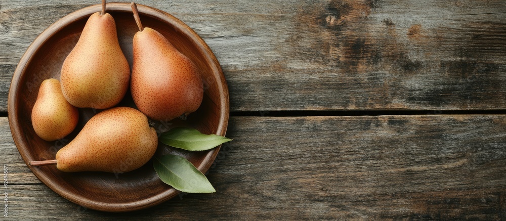 Fototapete Plate with fresh pears on a wooden table. with copy space image. Place for adding text or design