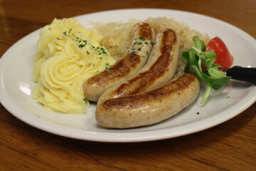 German cuisine: bratwurst (grilled pork sausages), mashed potatoes and sauerkraut (sour cabbage) in Frankfurt, Germany