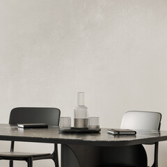 Modern black table and chairs with notebooks and glass of water, empty plaster wall, 3d render