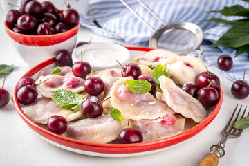 Traditional West Europe Dumplings with Cherries, ukrainian, polish vegan Cherry Pierogi, Sweet berry fruit Vareniki, ravioli with sour cream and sugar powder