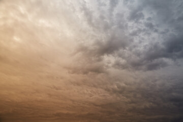 Morning sunlight on gray clouds in blue sky