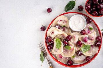 Traditional West Europe Dumplings with Cherries, ukrainian, polish vegan Cherry Pierogi, Sweet berry fruit Vareniki, ravioli with sour cream and sugar powder