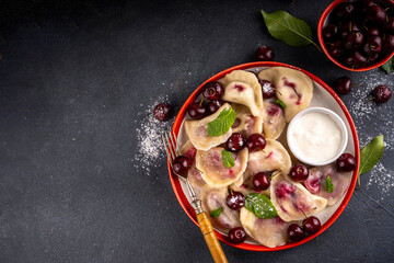 Traditional West Europe Dumplings with Cherries, ukrainian, polish vegan Cherry Pierogi, Sweet berry fruit Vareniki, ravioli with sour cream and sugar powder