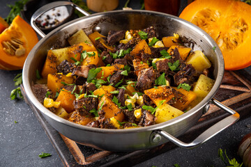 Warm pumpkin stew with potato and beef meat, comfort autumn dinner balanced food, with ingredients...