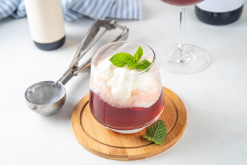 Wine Ice cream Floats cocktail, red wine cold drink with vanilla ice cream scoops, on white kitchen background, copy space
