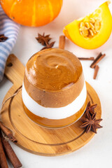 Pumpkin Spice Dalgona Coffee cocktail, sweet tasty autumn latte with pumokin puree, whipped cream and whipped instant dalgona coffee foam