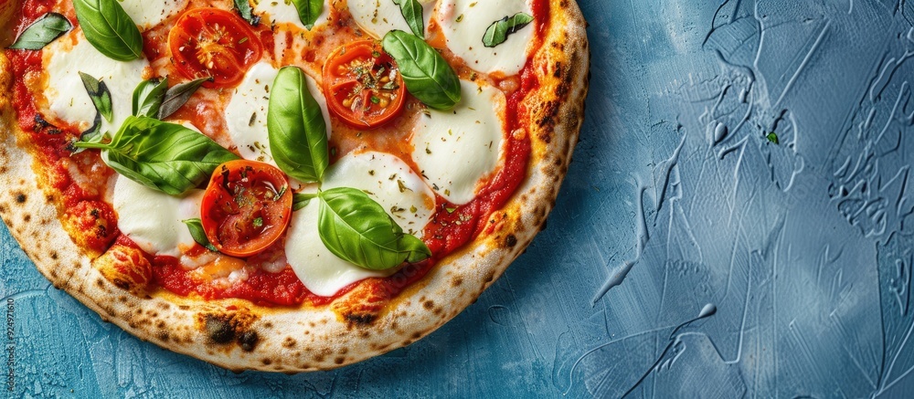 Aufkleber top down view of homemade margherita pizza with mozzarella fresh basil oregano and tomatoes on a blu