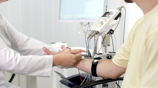 The patient undergoes an electromyography (EMG) test to assess nerve activity. Detects nerve and muscle dysfunctions. Perfect for showcasing advanced medical technologies