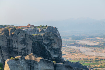 Monasteries located on unique rock formations in the Meteora region of Greece are illuminated by...